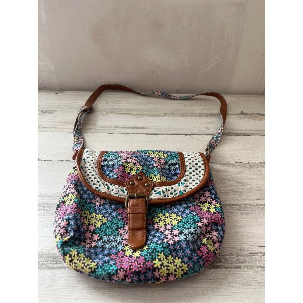 Light brown faux leather trimmed floral cloth bag with buckle snap closure